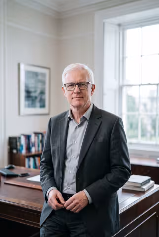Dean portrait, formal office background — Person `person_portrait`.